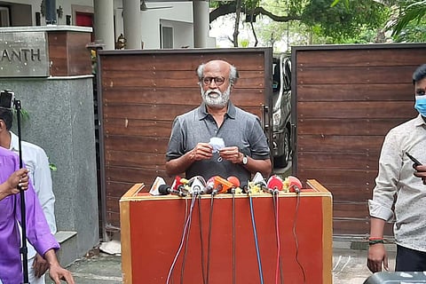 Actor Rajinikanth in a grey shirt addressing the media outside his house in Chennai