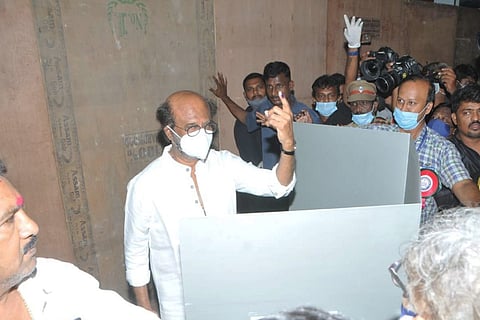 Rajinikanth shows his inked left finger to the media after voting on April 6 in Chennai