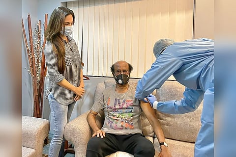 A medical professional is seen administering the vaccine to superstar Rajinikanth.