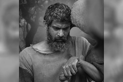 Rana Daggubati essays the role of an elderly person and looks dejected in a still from 'Aranya'.