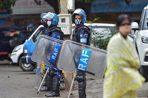 Rapid Action Force (RAF) personnel carry out a flag march in the riot-hit area, where a mob went on a rampage