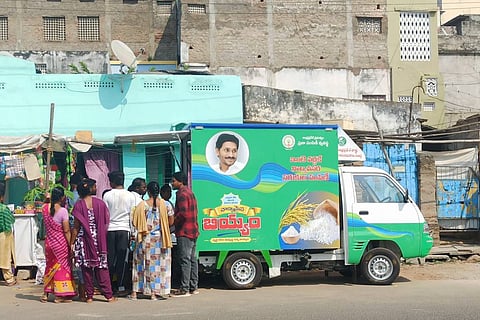 Ration door delivery vehicle in Vijayawada with card holders queued up for supplies