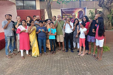 A group of people eating food during the solar eclipse on October 25 in Mangaluru