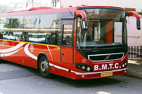 A red coloured BMTC AC bus used for airport journeys