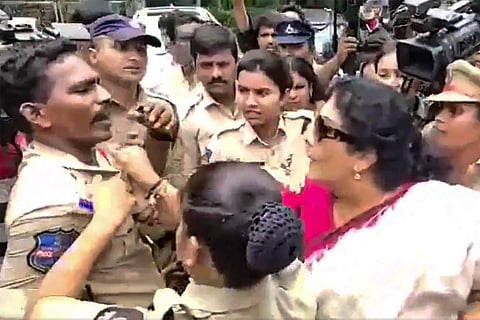 A screengrab from the video showing Renuka holding a police official's collar