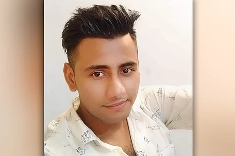 A file image of 25-year-old Rinku Sharma in a white shirt looking into camera