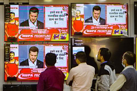 A group of Indians watching the news on the Russia Ukraine conflict