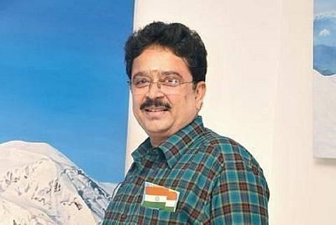 A image of BJP S Ve Shekar wearing blue stripped shirt and facing sideways