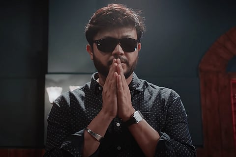 Ganesh dressed in black and wearing dark glasses in Sakkath poster