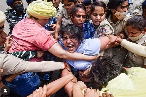 Sakshee Mallikh being detained by police
