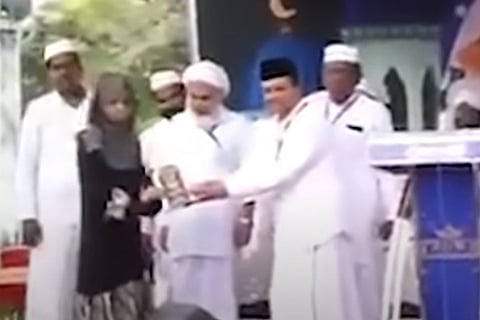 The girl receiving award from Samastha leaders