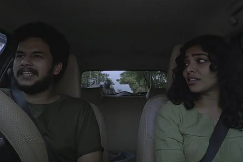 Malayalam actors Rima Kallingal and Jithin Puthencherry in a car for the movie Santhoshathinte Onnam Rahasyam