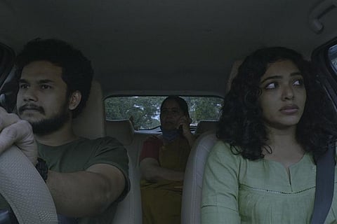 Actors Rima Kallingal, Jitin and Neeraja Rajendran inside the car.