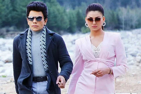Saravanan seen in a jacket and scarf on the left and Urvashi donning a pink dress on the right.