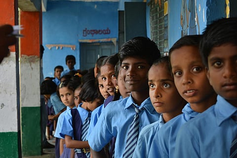 School kids standing in a line in a school in Karnataka
