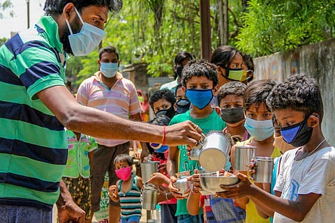 Milk being distributed to children in the pandemic in an Indian state