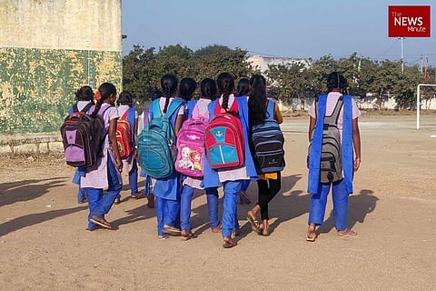 School girls with backpacks over their backs going to school