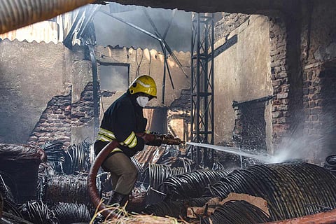 A fire fighter trying to douse the flames