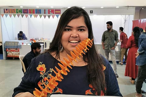 Seema Gurnani in a black kurta posing with chips