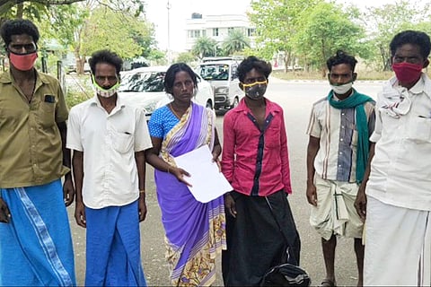 Selvarani's family members wearings masks stand together after handing over a complaint to the police