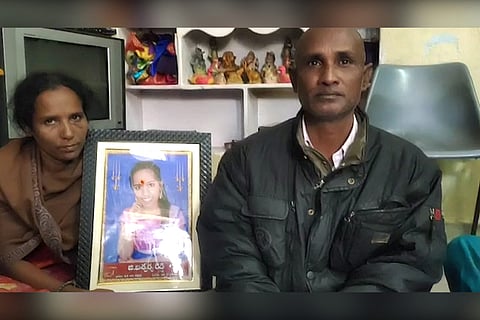 Parents of LSR student Aishwarya Reddy who died by suicide holding up her photograph