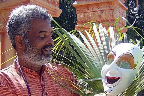Veteran art director Shashidhara Adapa holding a mask
