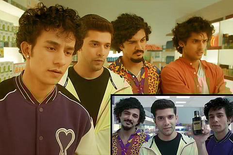 Four men staring at something, and three men with a perfume bottle