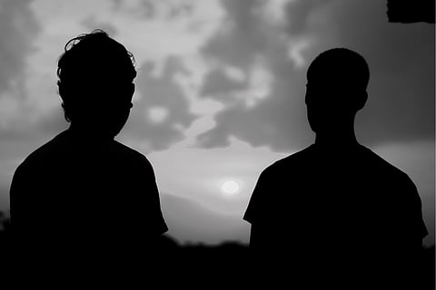 Silhouette of two men against the skyline