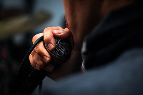 A man singing into a mic