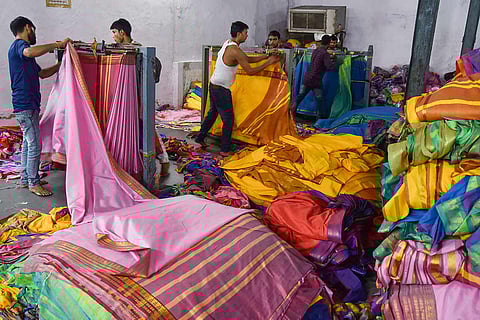 Workers in a textile unit working on Bathukamma saris