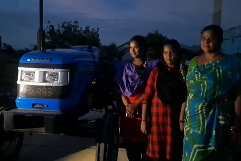 Family of Chittoor farmer standing next to tractor sent by Sonu Sood