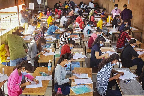 Students writing an exam wearing masks in Allahabad in September 2020