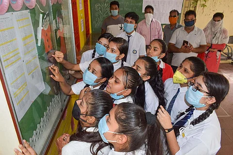 Class 10 board exam 2021 results: Students gather around a notice board to look for their roll numbers after declaration of exam results