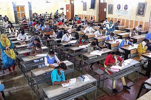 Students writing exams in a hall