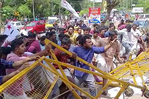 Protestors trying to enter through yellow colored barricades