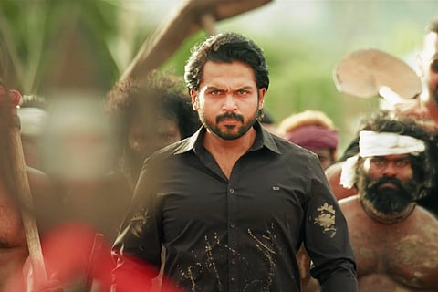Karthi seen donning a black shirt in a still from 'Sulthan'.