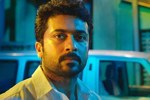 Suriya is seen wearing a white shirt in the close-up shot.