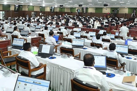 Tamil Nadu MLAs sitting before laptops in the state Assembly