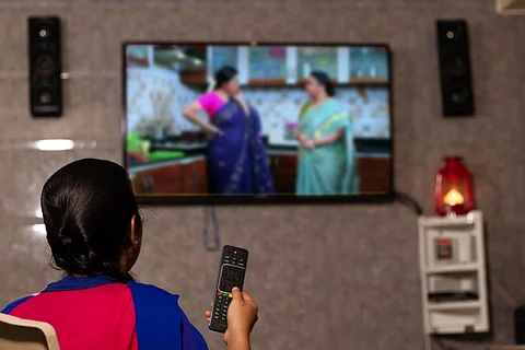 A woman watching a TV serial