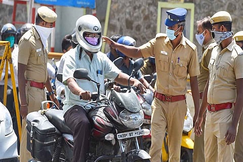Police officers inspecting a bike rider
