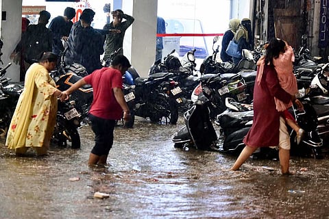 People stranded in heavy rain.