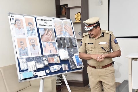 A police officer looking at a board displaying details about the crime
