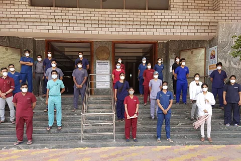 doctors holding posters outside the hospital by boycotting their duties