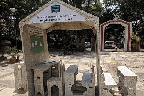 A classroom with desk and benches made of recycled paper