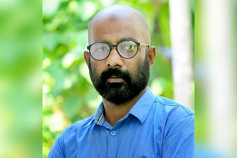 Kannur native VK Thajudheen, who was wrongfully arrested for chain-snatching, in a blue shirt and glasses
