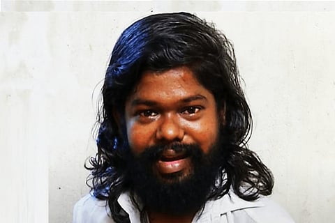 Close-up shot of Tamil actor Theepetti Ganesan. He is wearing a white shirt.