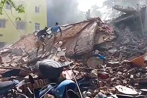 Visuals from the site of the building collapse show workers trying to remove debris