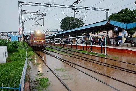 Train passing through flooded railway tracks