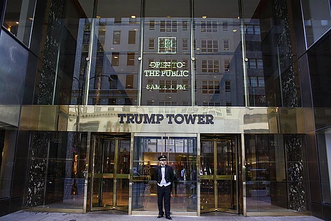A doorman stands outside the Trump Tower in New York
