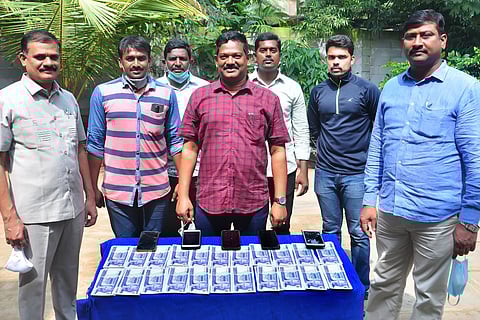 Vijayawada police standing in front of seized Turkish lira notes
